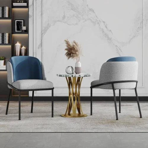 Set of 2 modern chairs with slant chair legs and adjustable feet in grey and marine colors around a gold metal side table in a minimalist living room setting