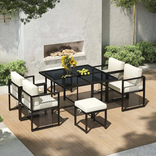 Outdoor 7-piece garden lounge set with black metal frame, glass table, and white cushions for six people.