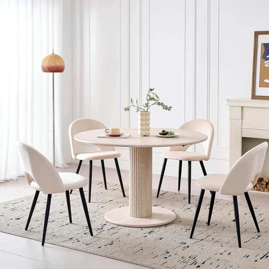 Modern round solid wood dining table for 4-6 people with beige chairs in a stylish Nordic design room