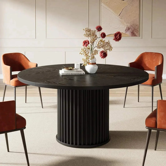 Modern black round dining table for 4 with sturdy metal base in stylish dining room setting